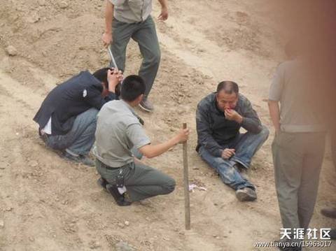 陜AWK707的西安城管執(zhí)法車和6名穿制服的城管，手持棍棒，在郊外毆打兩名倒地男子。 