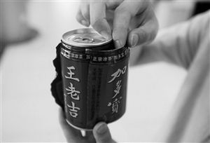 撕開加多寶罐子外的一層包裝紙，里面露出了“王老吉”的字樣。（圖片來源：現(xiàn)代金報）